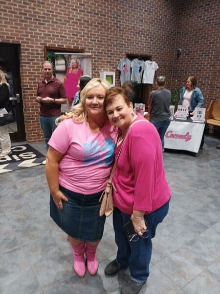 Susan with a fan at the merch booth