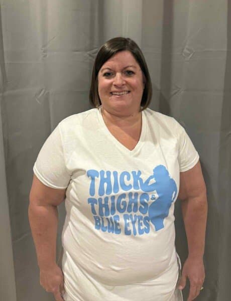 Fan showing off a Thick Thighs & Blue Eyes tee