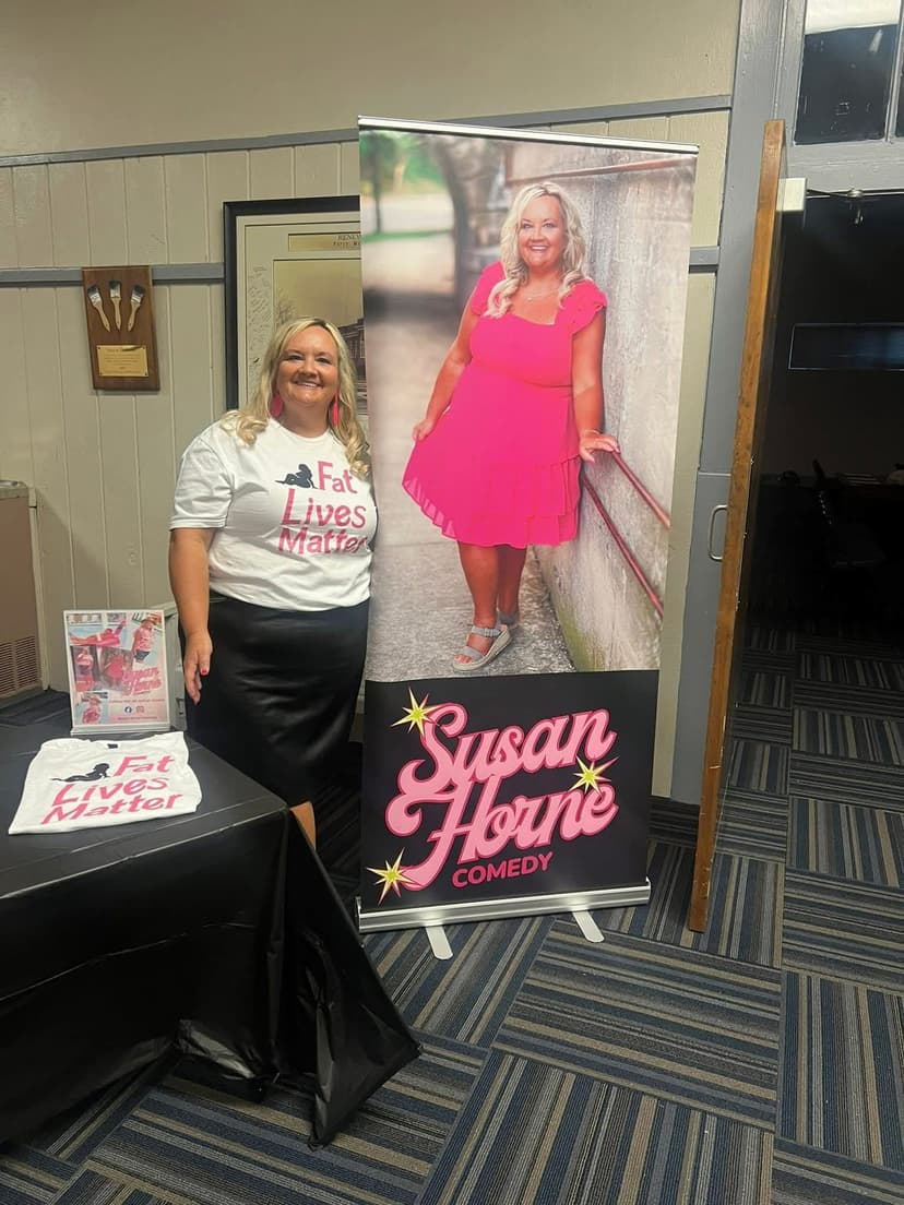 Susan Horne with comedy banner